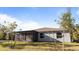 View of the home's screened-in back porch with a view of the backyard and blue sky at 2784 Dode Ave, North Port, FL 34288