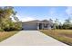 Well-manicured lawn and a large concrete driveway lead up to this cozy home at 2784 Dode Ave, North Port, FL 34288