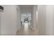 Bright hallway with neutral-colored tile floors leading to the living area at 2784 Dode Ave, North Port, FL 34288