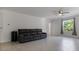 Open living space with tile floors, a ceiling fan, and large windows at 2784 Dode Ave, North Port, FL 34288
