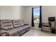Comfortable living area with a reclining sofa, desk, and window at 2784 Dode Ave, North Port, FL 34288