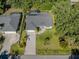 Aerial view of a well maintained green home with lush landscaping and screened pool at 3341 Briant St, North Port, FL 34287
