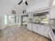 Open kitchen and breakfast nook with white cabinets, granite countertops, and large window overlooking the pool area at 3341 Briant St, North Port, FL 34287