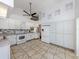 Spacious kitchen with stainless appliances, white cabinets, and tiled flooring at 3341 Briant St, North Port, FL 34287