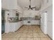 Spacious kitchen features white cabinetry, stainless steel appliances, and tiled flooring at 3341 Briant St, North Port, FL 34287