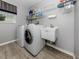This laundry room has a washer, dryer, and utility sink at 3341 Briant St, North Port, FL 34287