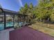 Outdoor patio with brick pavers features an enclosed pool and a decorative bench with plants, perfect for relaxation at 3341 Briant St, North Port, FL 34287