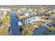 Aerial view of waterfront property with boat dock and lush landscaping at 4297 Nettle Rd, Port Charlotte, FL 33953
