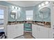 Bathroom featuring double sinks, granite countertops, and white cabinets at 4297 Nettle Rd, Port Charlotte, FL 33953