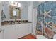 Bathroom with a vanity featuring a granite countertop and a decorated starfish mirror at 4297 Nettle Rd, Port Charlotte, FL 33953