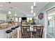 Open-concept dining area with a white table, chairs, and modern lighting at 4297 Nettle Rd, Port Charlotte, FL 33953