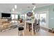 Open-concept dining area features a white table, seating for four, and sliding glass doors to the outdoor deck at 4297 Nettle Rd, Port Charlotte, FL 33953