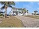 Two-story waterfront home with a brick driveway and lush landscaping at 4297 Nettle Rd, Port Charlotte, FL 33953