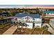 An aerial view showcases a waterfront home with a spacious porch and a garage underneath at 4297 Nettle Rd, Port Charlotte, FL 33953