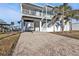 Inviting two-story waterfront home with a brick driveway and covered parking at 4297 Nettle Rd, Port Charlotte, FL 33953