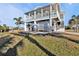 Elevated home with ample parking, outdoor seating, and lush landscaping at 4297 Nettle Rd, Port Charlotte, FL 33953