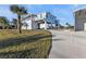 Beautiful 2-story home with a lift, a large covered area for cars, and palm trees at 4297 Nettle Rd, Port Charlotte, FL 33953