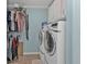 Bright laundry room featuring side-by-side washer and dryer and wire shelving for storage at 4297 Nettle Rd, Port Charlotte, FL 33953
