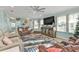 Comfortable living room featuring a ceiling fan, large TV, and cozy leather furniture at 4297 Nettle Rd, Port Charlotte, FL 33953