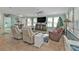 Spacious living room with ample seating, large windows, and a modern ceiling fan at 4297 Nettle Rd, Port Charlotte, FL 33953