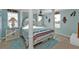 Cozy main bedroom with a decorative four-poster bed, stylish furnishings, and soft blue accents at 4297 Nettle Rd, Port Charlotte, FL 33953