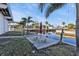 Outdoor seating next to a canal with a table, benches, and umbrella for shade at 4297 Nettle Rd, Port Charlotte, FL 33953