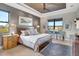 Comfortable bedroom featuring a ceiling fan, large windows, and stylish furniture at 5221 Almar Dr, Punta Gorda, FL 33950