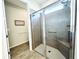 Bathroom showcasing a glass-enclosed shower with tile surround and a built-in shower seat at 8117 Thruso Rd, Port Charlotte, FL 33981