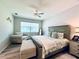 Comfortable bedroom features a ceiling fan, window for natural light and decorative headboard above the bed at 8117 Thruso Rd, Port Charlotte, FL 33981