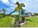 Beautifully landscaped corner lot with vibrant tropical foliage and plants around the house at 8117 Thruso Rd, Port Charlotte, FL 33981