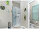 Bright bathroom featuring a walk-in shower with decorative tile accents and glass door at 8242 Lakeside Dr, Englewood, FL 34224