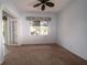 Light-filled bedroom with carpet flooring and a view of the backyard at 8242 Lakeside Dr, Englewood, FL 34224