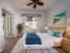 Cozy bedroom with coastal decor, wicker accents, and view to the yard at 8242 Lakeside Dr, Englewood, FL 34224