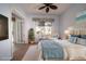 Light-filled bedroom with coastal decor, wicker chair, and view to exterior at 8242 Lakeside Dr, Englewood, FL 34224