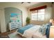 Bright bedroom with wicker bed frame, coastal-themed accents, and dresser at 8242 Lakeside Dr, Englewood, FL 34224