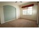 Empty bedroom with a large window and plush carpet at 8242 Lakeside Dr, Englewood, FL 34224