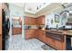 Kitchen featuring wood cabinets, stainless steel appliances, and tile backsplash at 8242 Lakeside Dr, Englewood, FL 34224