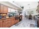 Kitchen featuring wood cabinets, stainless steel appliances, and tile backsplash at 8242 Lakeside Dr, Englewood, FL 34224