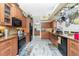 Kitchen featuring wood cabinets, stainless steel appliances, and tile backsplash at 8242 Lakeside Dr, Englewood, FL 34224
