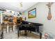 View of living room featuring black piano and decor at 8242 Lakeside Dr, Englewood, FL 34224