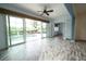Spacious living area with wood flooring and sliding glass doors leading to the pool at 8242 Lakeside Dr, Englewood, FL 34224