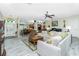 Open-concept living room featuring neutral walls, hardwood floors, and abundant natural light at 8242 Lakeside Dr, Englewood, FL 34224