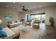 Bright living room with neutral walls, wicker furniture and decor at 8242 Lakeside Dr, Englewood, FL 34224