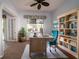 Bright office space with wood desk, blue chair, and built-in bookshelves at 8242 Lakeside Dr, Englewood, FL 34224