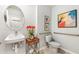 Stylish powder room featuring modern fixtures, vanity, and decorative artwork at 9374 Sunbeam Cir, Punta Gorda, FL 33950