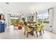 Bright open-concept living space with a dining area and sliding glass doors leading to the outdoors at 9452 Sunbeam Cir, Punta Gorda, FL 33950