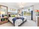 Comfortable main bedroom features a plush bed, soft lighting, and a large window with a backyard view at 9452 Sunbeam Cir, Punta Gorda, FL 33950