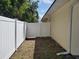 Side yard access through the white vinyl gate, complete with a secure enclosure at 1057 Staley St, Port Charlotte, FL 33952