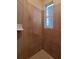 A simple shower room featuring tile walls and flooring and a window for natural light at 1057 Staley St, Port Charlotte, FL 33952