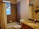 Bathroom with tiled shower and granite countertop vanity at 1057 Staley St, Port Charlotte, FL 33952